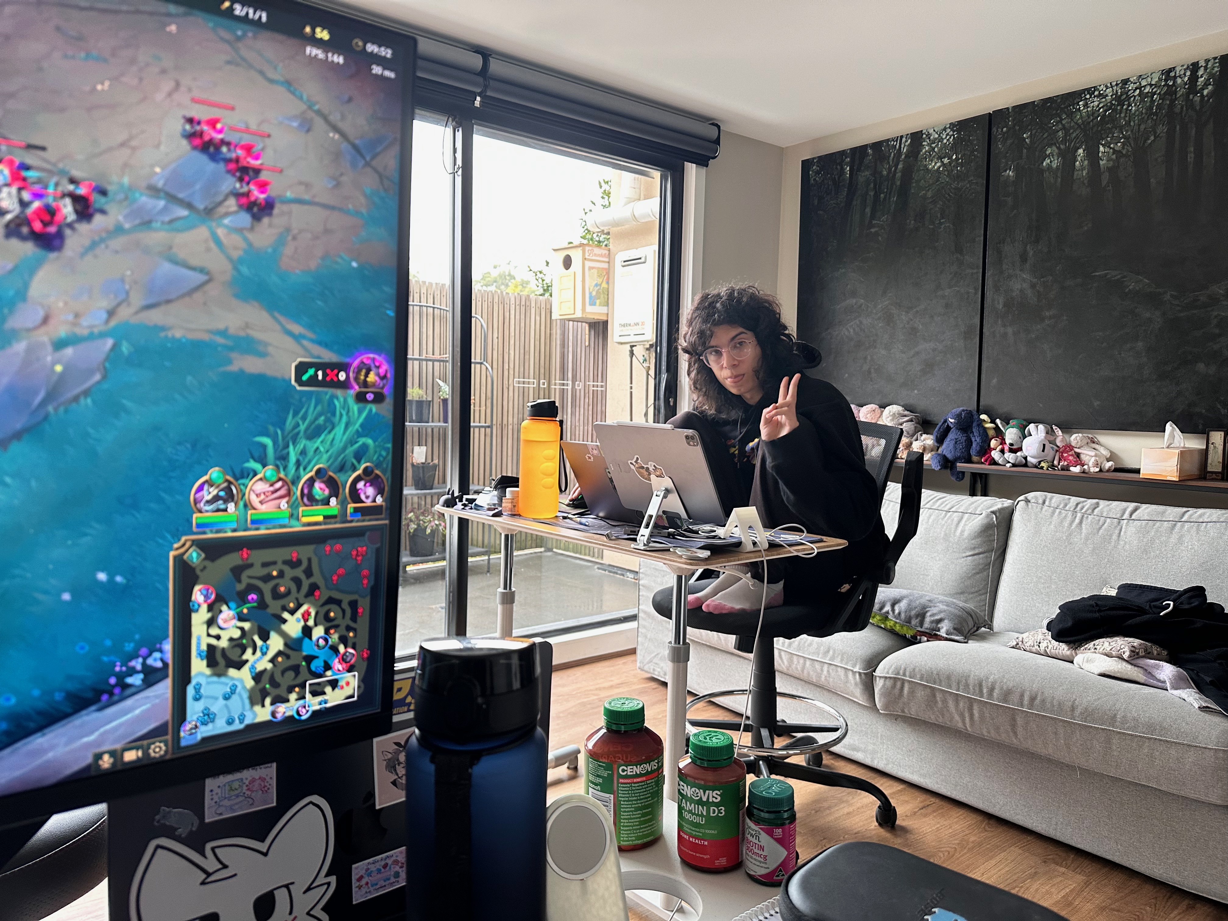 photo of Annie flashing a peace sign while squatting on her chair like a little gremlin