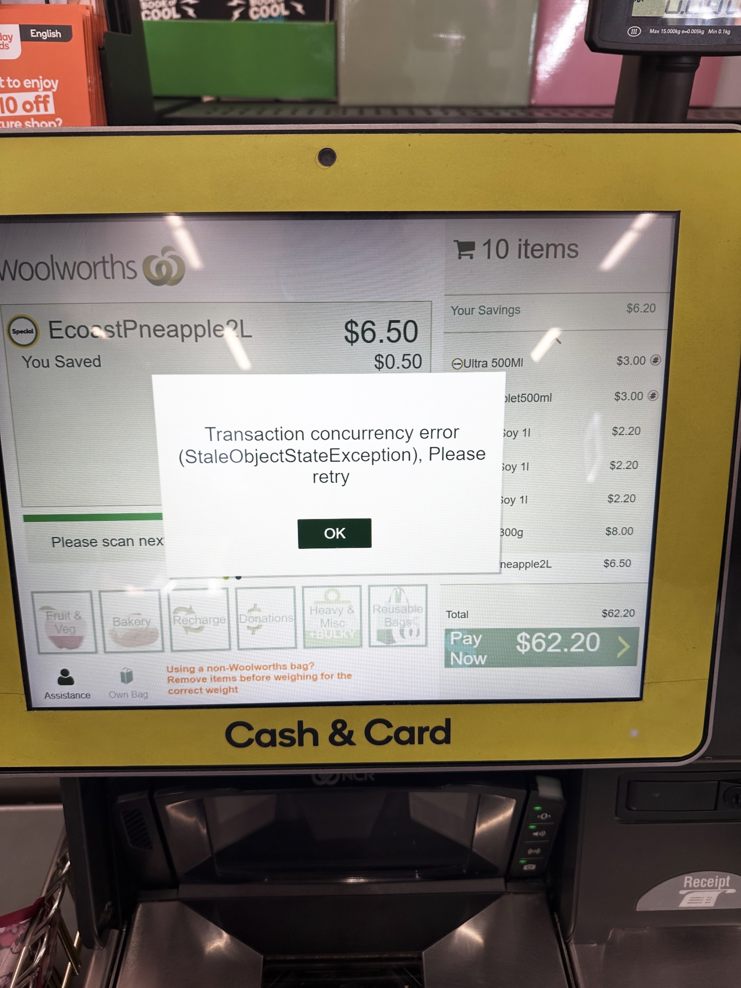 Photograph of a Woolworths self-checkout machine, with an error message: “Transaction concurrency error (StaleObjectStateException), Please retry”